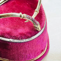 Side profile of a vintage gold snake bracelet highlighting its flexible sprung construction and wrap design.