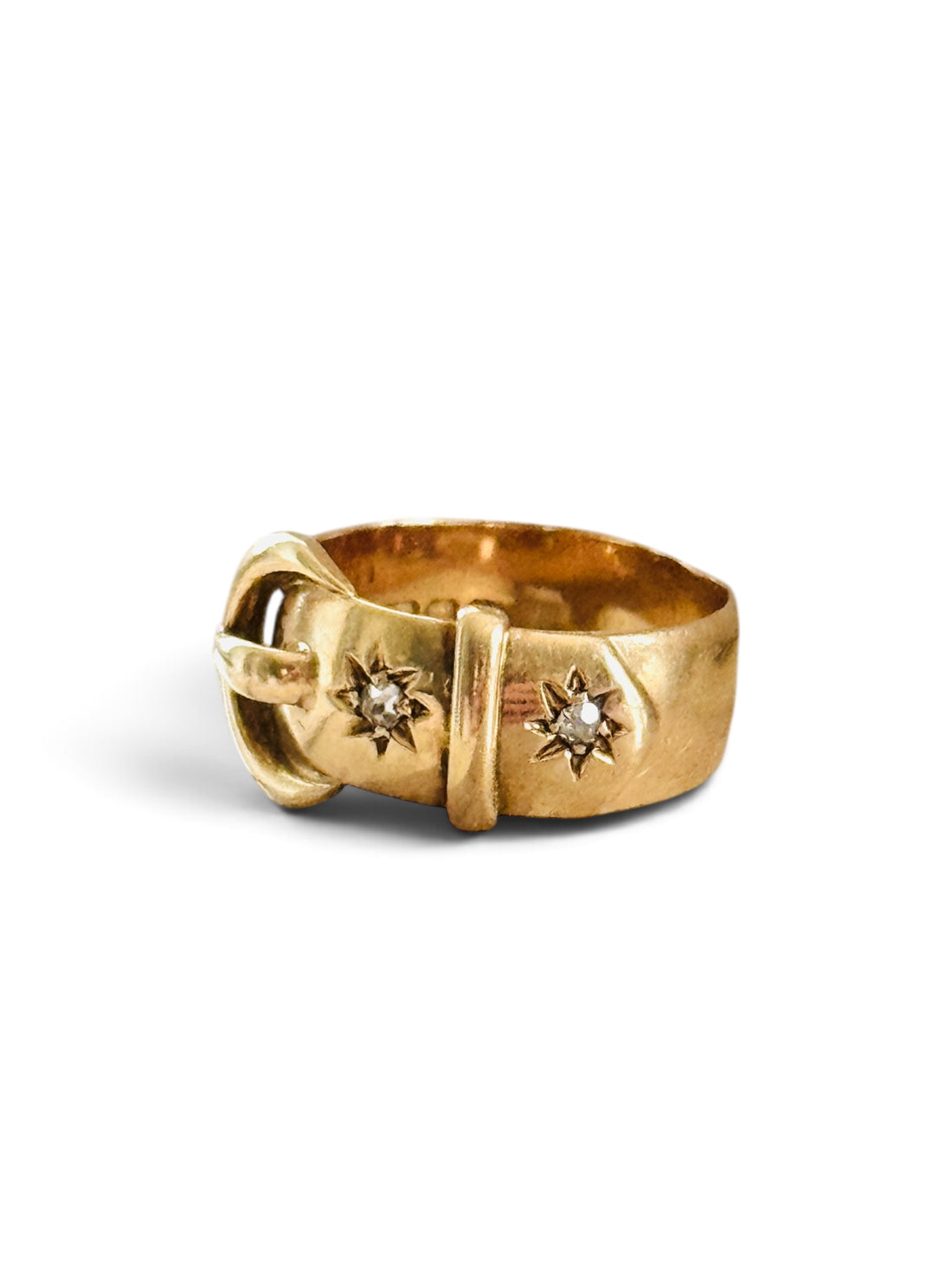 Three-quarter view of an original English 18K gold buckle ring with two old European cut diamonds, London hallmarked circa 1916.