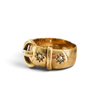 Three-quarter view of an original English 18K gold buckle ring with two old European cut diamonds, London hallmarked circa 1916.