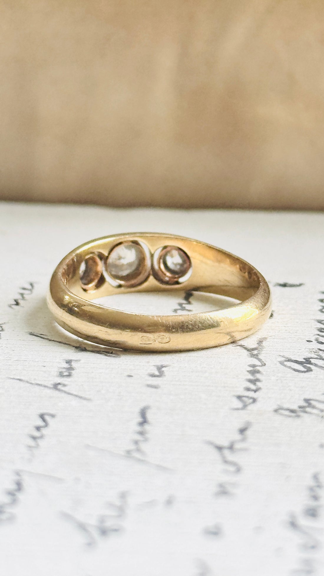 Top view of an Art Deco diamond ring showing the sculpted gold band and diamond placement