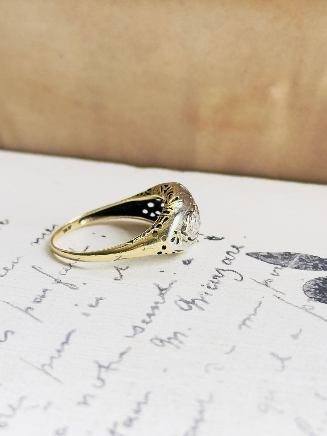 Two-tone gold vintage diamond ring with delicate openwork side details
