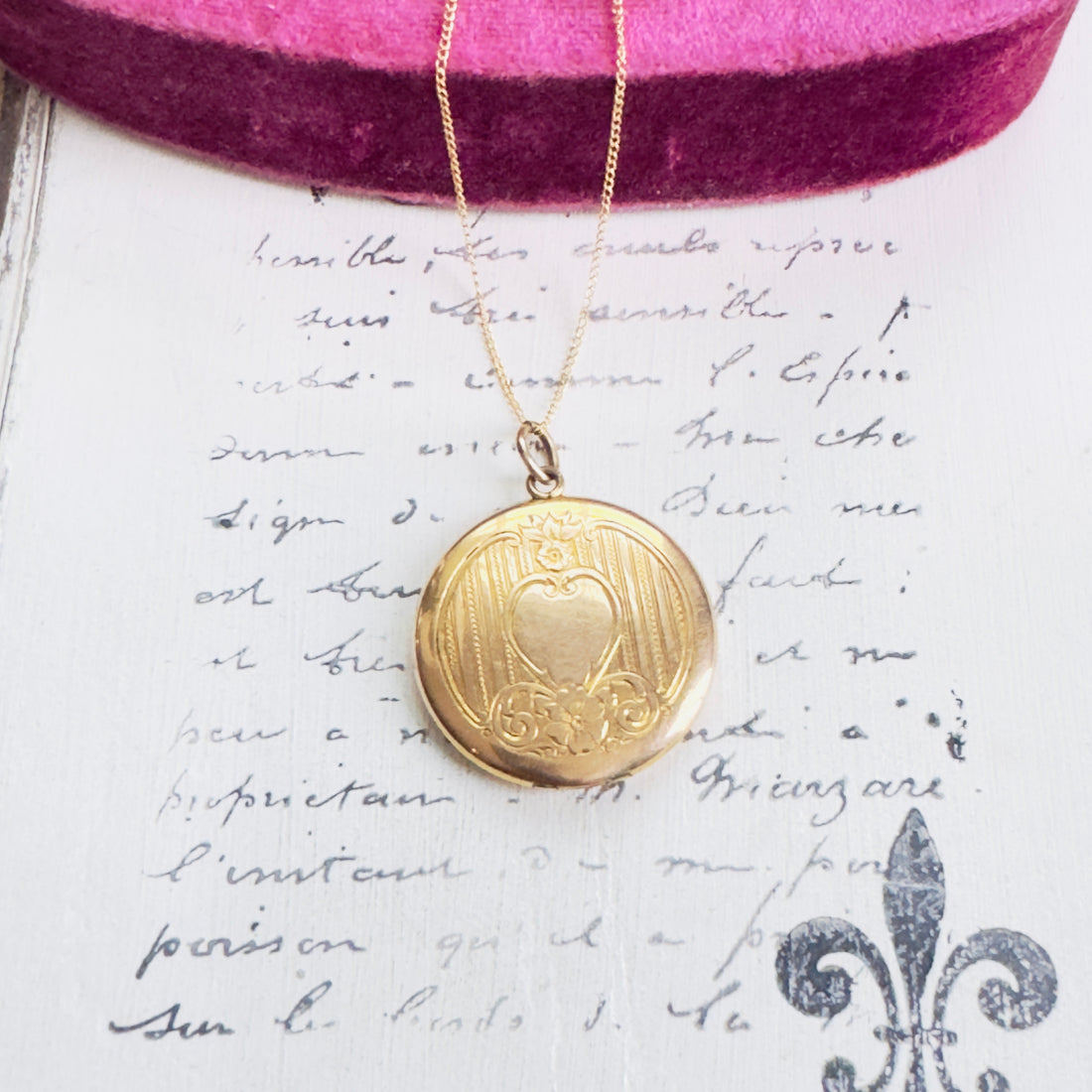 Close-up of engraved scroll and heart detailing on vintage locket