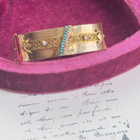 Victorian 18k gold hinged bangle bracelet featuring turquoise and seed pearls