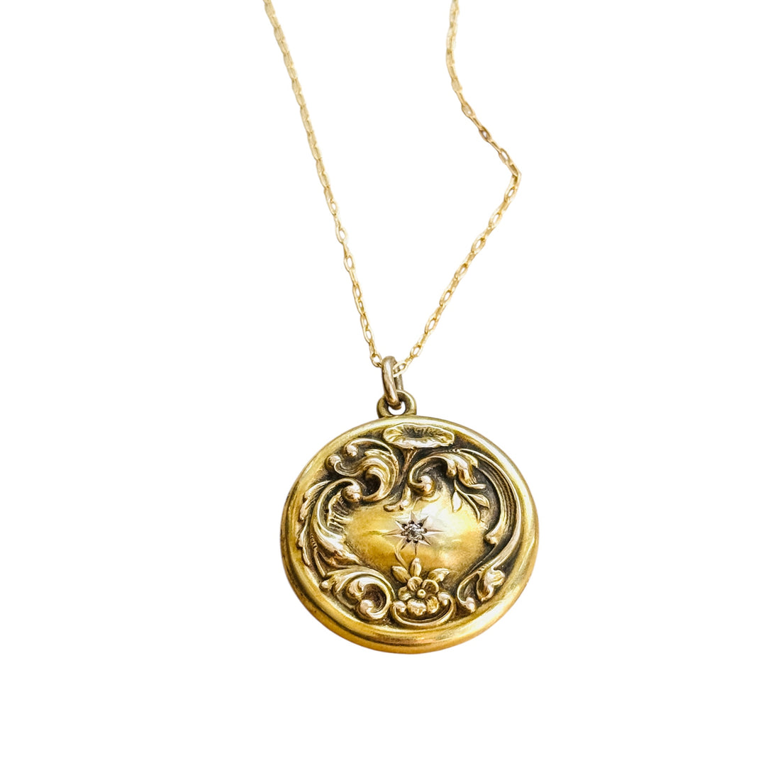 Victorian Art Nouveau 14K gold diamond locket with repoussé scrollwork.