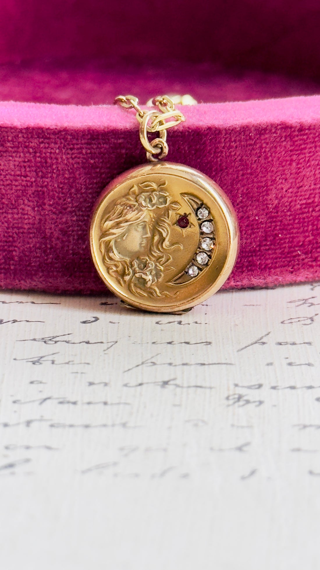 Antique celestial locket featuring a woman and crescent moon design