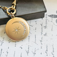 Victorian crescent moon locket paired with an antique French ORIA watch chain, styled on handwritten French paper.