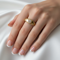 Victorian gold ring with hand-engraved scroll shoulders and diamond cluster face