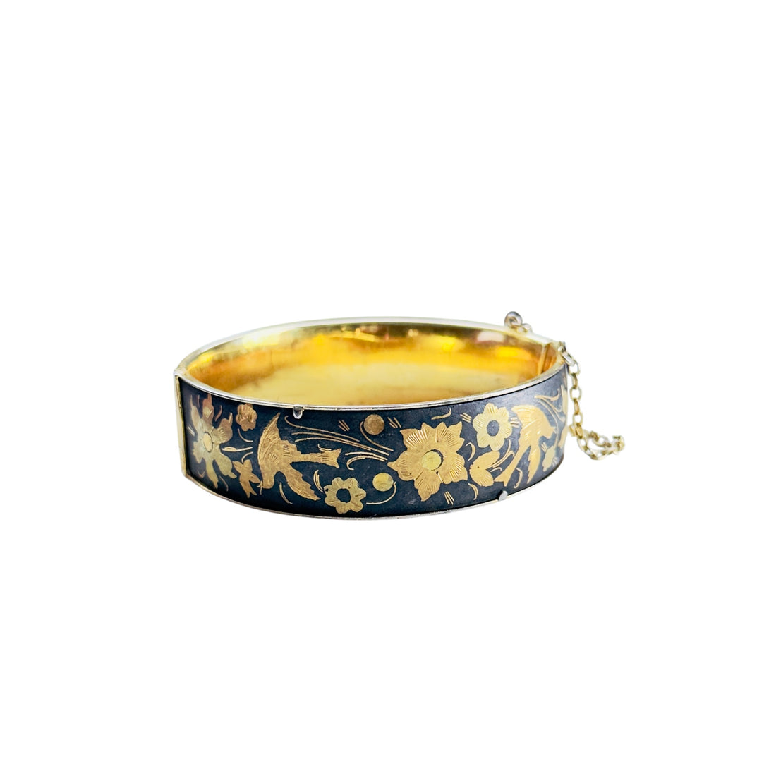 Vintage black and gold damascene-style hinged bangle bracelet with floral and bird motif