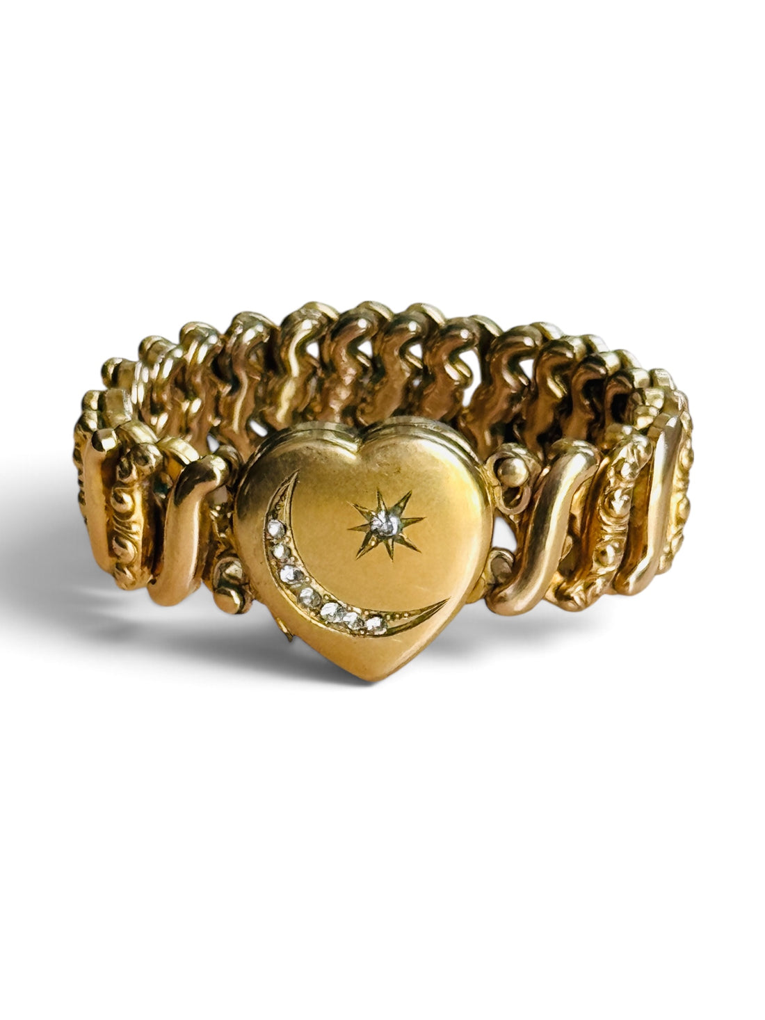 Vintage gold-filled Carmen sweetheart bracelet with stone-set crescent moon and star heart locket on a white background