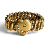 Vintage gold-filled Carmen sweetheart bracelet with stone-set crescent moon and star heart locket on a white background