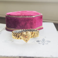 Vintage gold filled sweetheart bracelet by Bigney with Florentine finish and hand-engraved heart center with floral scrollwork