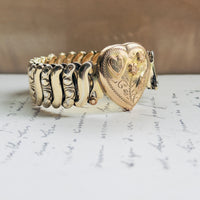 Vintage gold filled sweetheart expansion bracelet by Jewel Guild with scroll-engraved band links, pink enamel florals, and engraved heart center