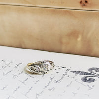 Vintage three-diamond ring with white gold bezels and yellow gold band