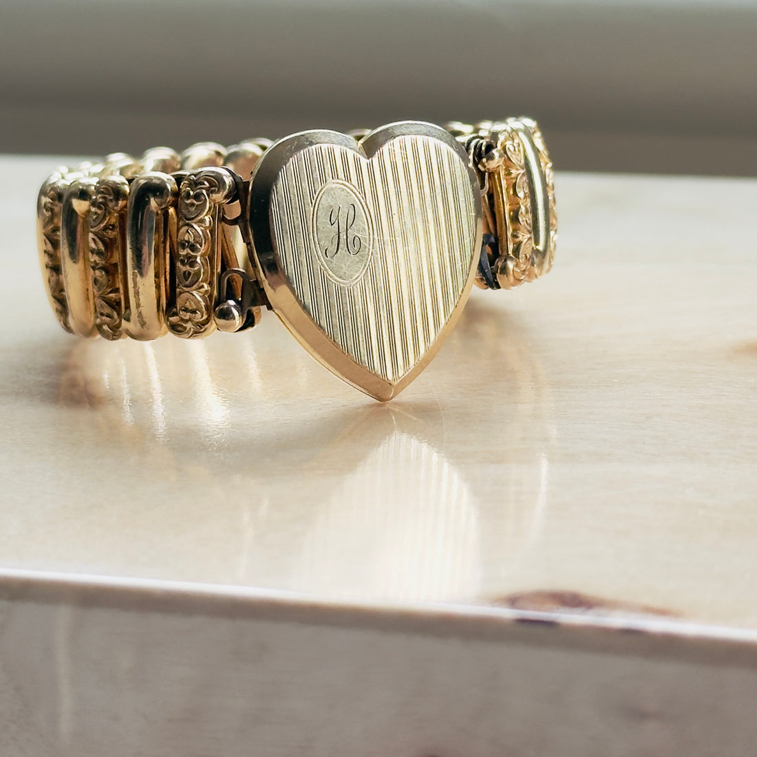 What is a locket sweetheart bracelet? Signed LACO vintage expansion bracelet with heart locket holding two photos, mid-century estate piece