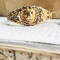 Antique Edwardian gold filled lion head bangle bracelet with engraved scrollwork, styled on a handwritten letter