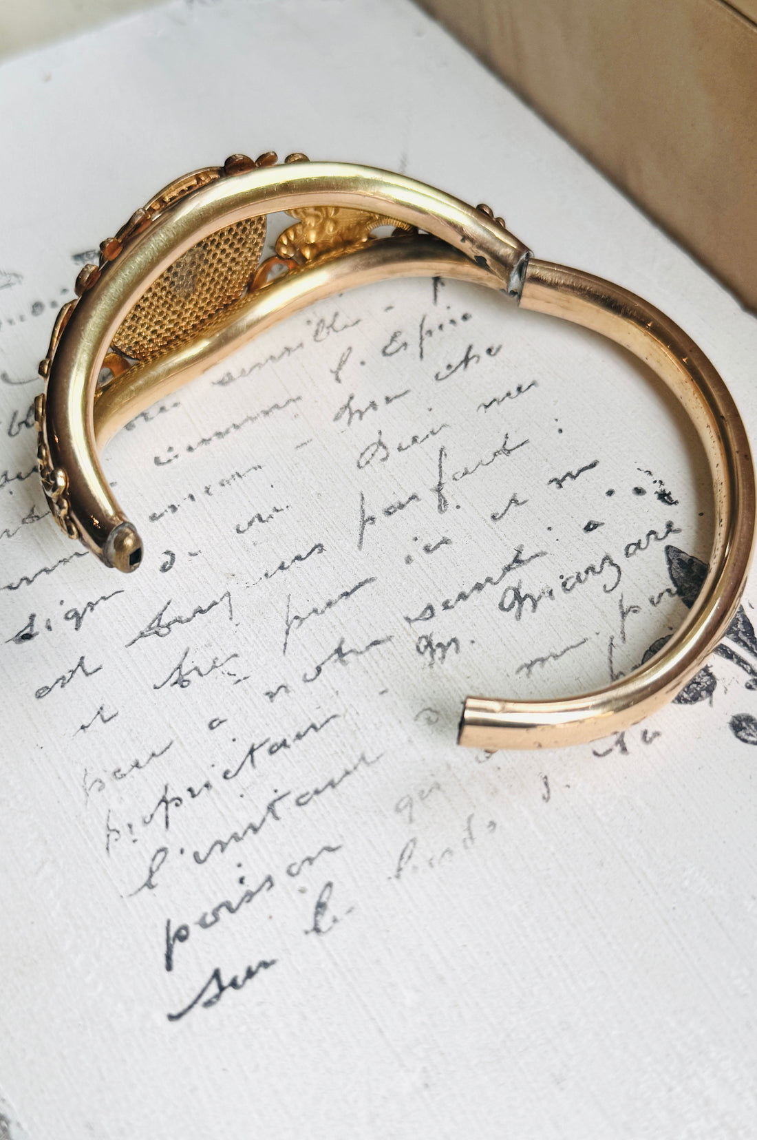 Antique gold filled lion head bangle shown open to reveal the hinged opening and smooth inner band