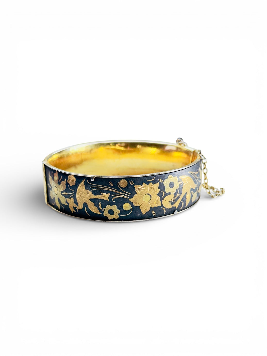 black and gold damascene-style hinged bangle bracelet with floral and bird motif