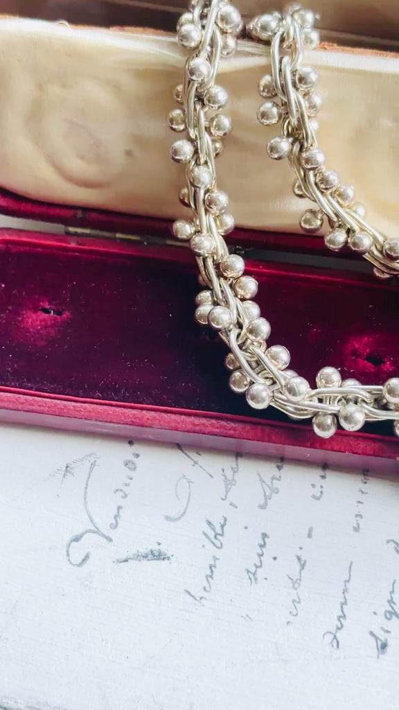 Video of vintage sterling silver peppercorn necklace highlighting the movement, texture, and toggle clasp.