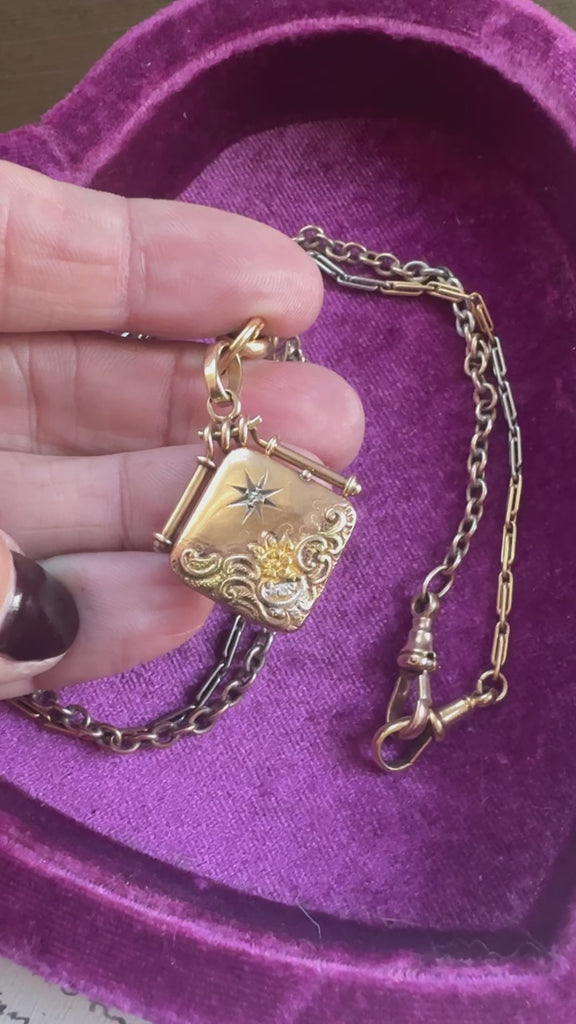 Closeup of 14k gold locket with center diamond starburst detail