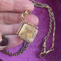 Closeup of 14k gold locket with center diamond starburst detail