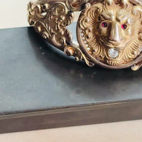 Video of Edwardian gold filled lion head hinged bangle bracelet showing the lion's red paste eyes and engraved scroll details