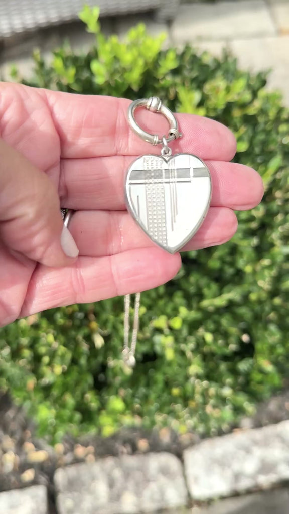 Vidoe of Art Deco sterling silver heart locket pendant with engraved geometric detail.