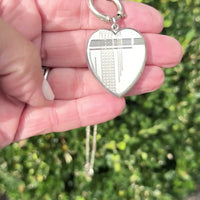 Vidoe of Art Deco sterling silver heart locket pendant with engraved geometric detail.