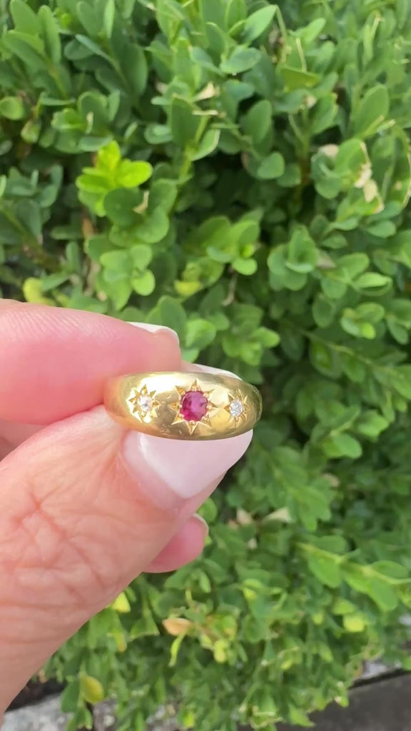 Close-up of Victorian 18k gold ring with ruby center stone and diamond accents, star-set flush in domed polished band, size 6
