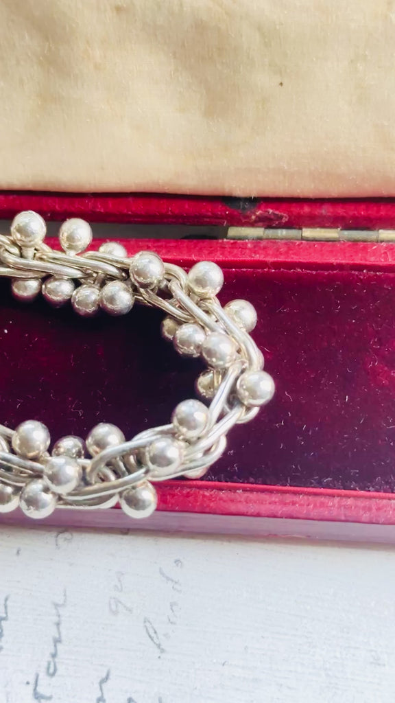 Video showing vintage sterling silver bead ball helix necklace from multiple angles with polished sterling silver finish.