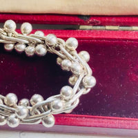 Video showing vintage sterling silver bead ball helix necklace from multiple angles with polished sterling silver finish.