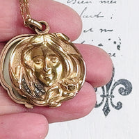 Elegant Art Nouveau 18k gold locket featuring a raised female figure and diamond accents