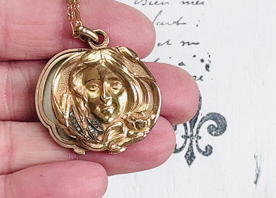 Elegant Art Nouveau 18k gold locket featuring a raised female figure and diamond accents