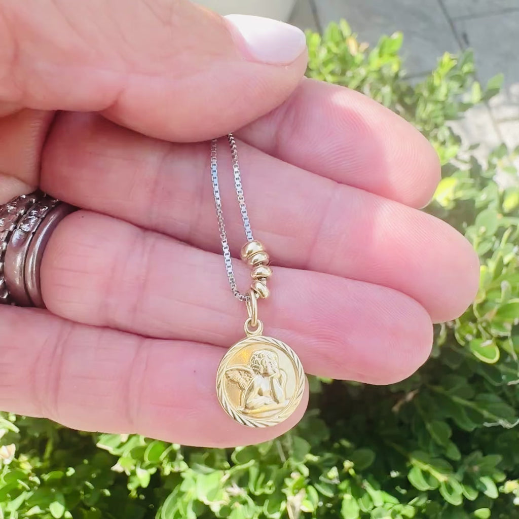 Video showcasing an original Victorian 14k gold cherub pendant on an adjustable sterling silver slider chain.