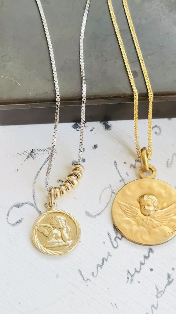 Video showing the antique FIX cherub medal, gold chain, scale, movement, and front and reverse details.