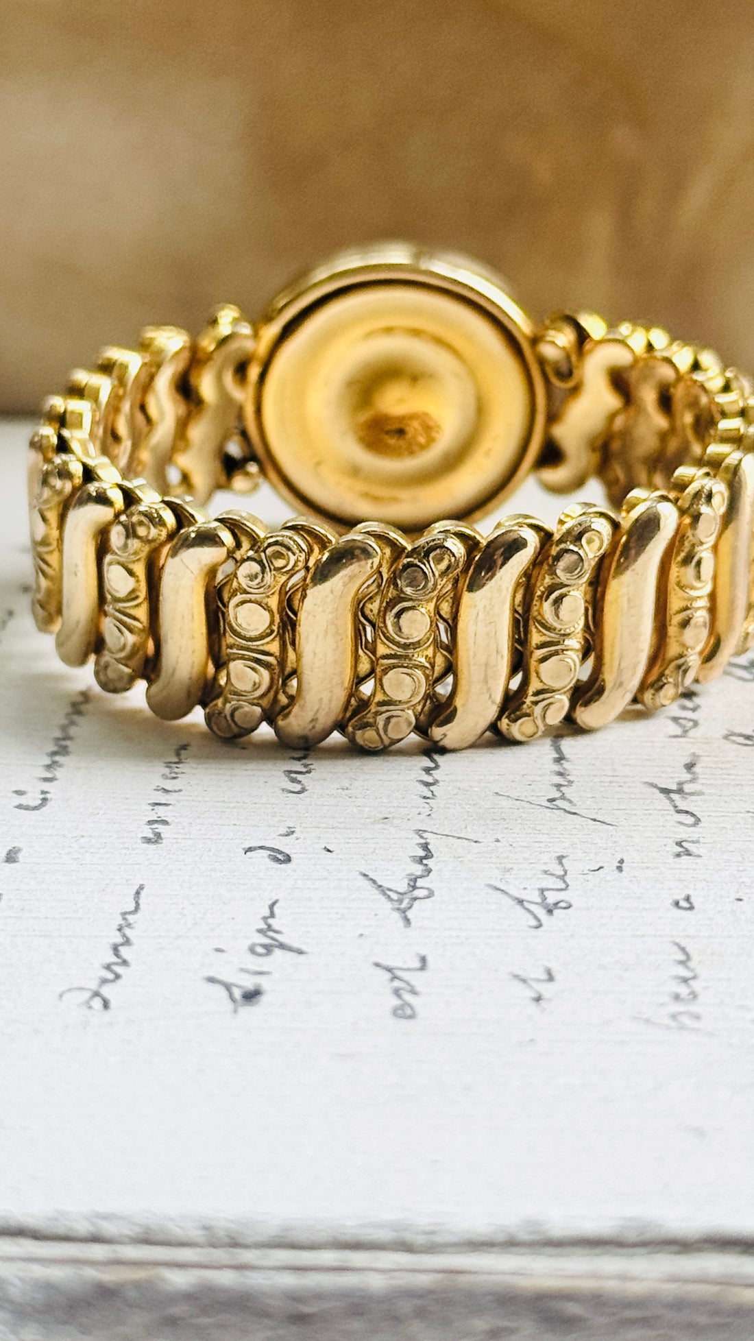 Reverse of vintage Gloria sweetheart bracelet showing the back of the round center and gold filled expansion links