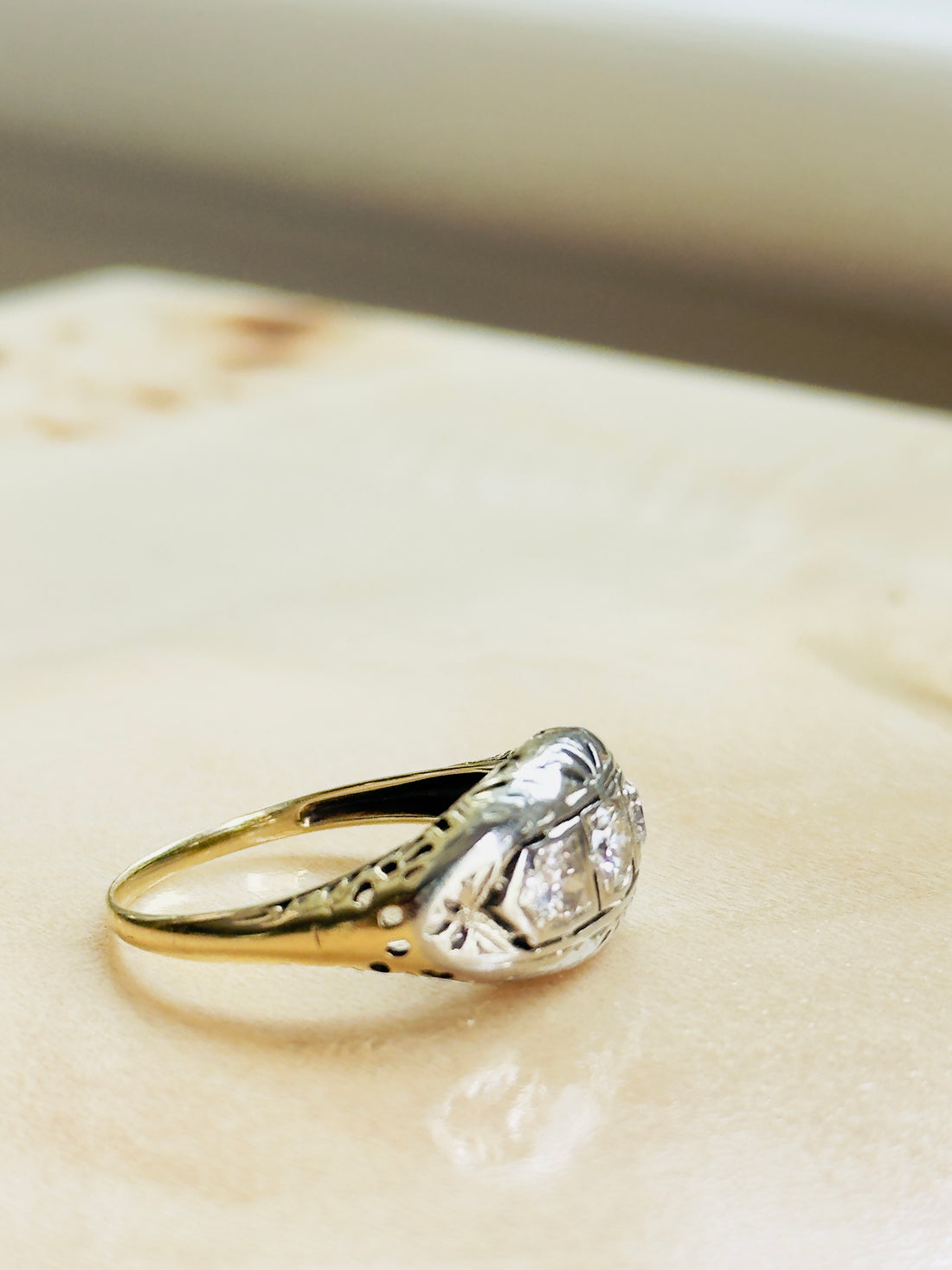 three-diamond ring with white gold bezels and yellow gold band
