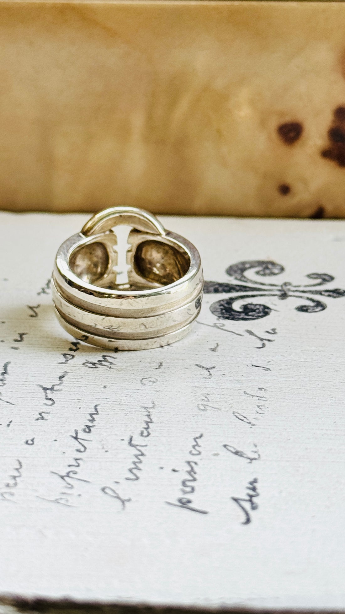 Tiffany Atlas sterling silver ring standing upright, showing the ribbed bands and loop