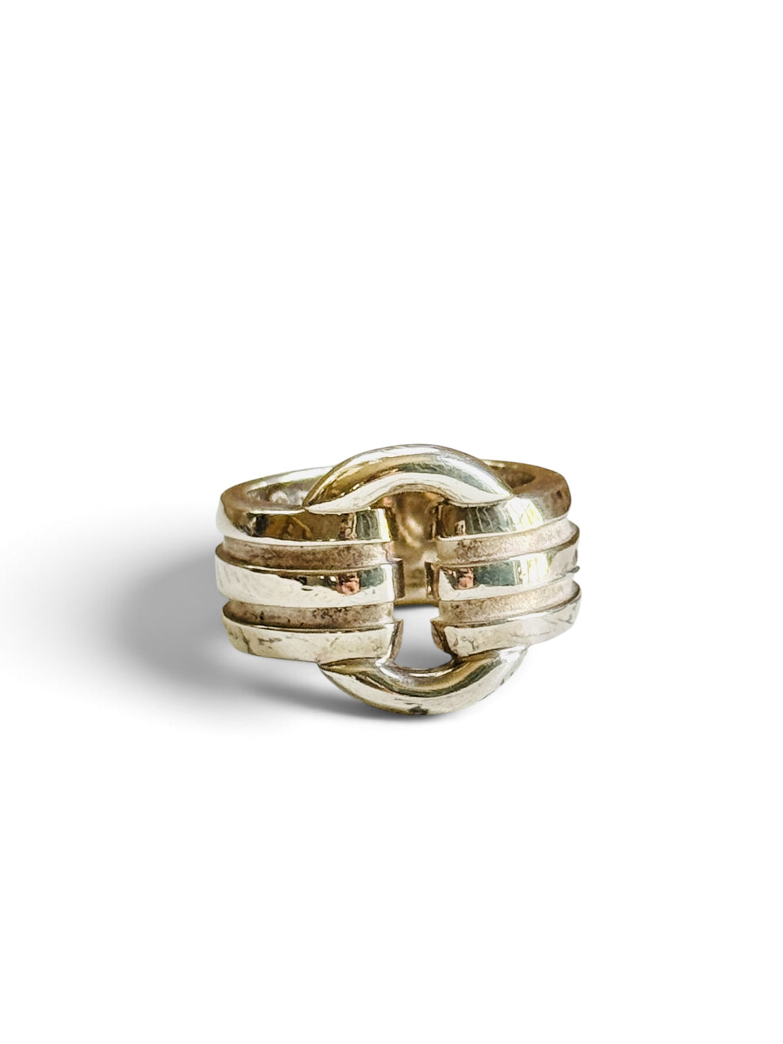 Tiffany & Co. Atlas sterling silver ring with three ribbed bands and an open loop, on a white background