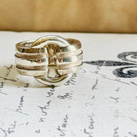 Front view of the Tiffany Atlas sterling silver ring styled on vintage script paper