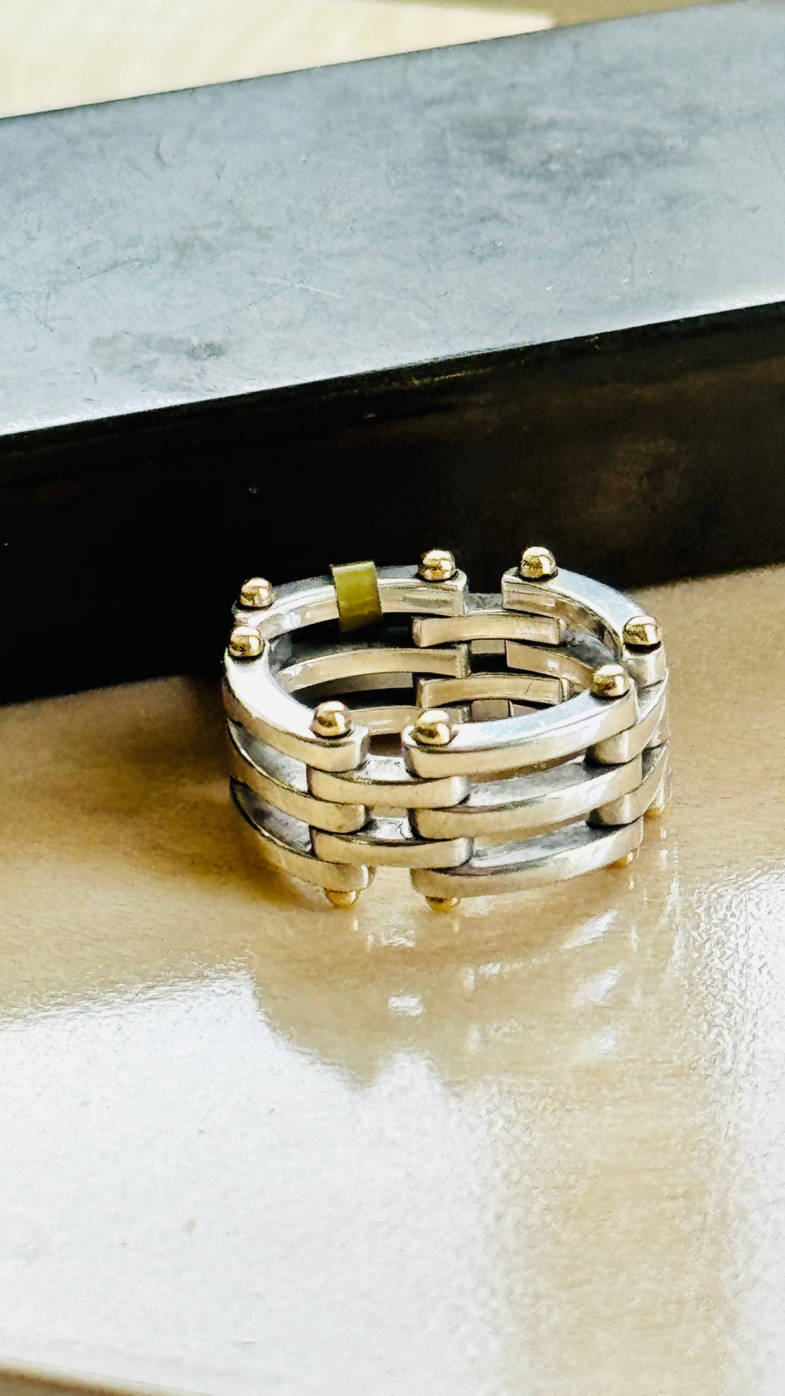 Vintage Tiffany Gate Link ring in sterling silver and 18k gold on a marble surface