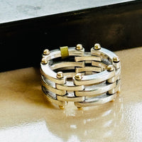 Vintage Tiffany Gate Link ring in sterling silver and 18k gold on a marble surface
