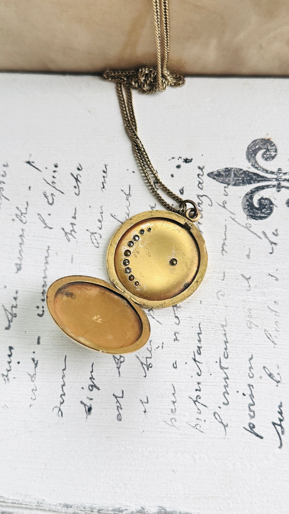 Close-up of the open W&H Co. gold filled crescent moon locket showing the interior