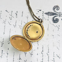 Close-up of the open W&H Co. gold filled crescent moon locket showing the interior
