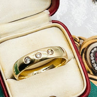 Trilogy gold diamond band ring with diamonds.